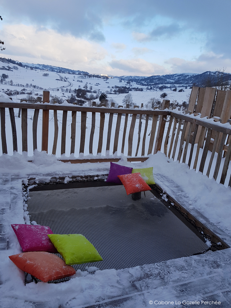 Hamac géant intégré à la terrasse de ce gîte aux pieds des montagne